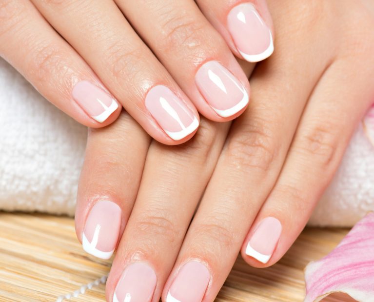 Beautiful woman's nails with french manicure