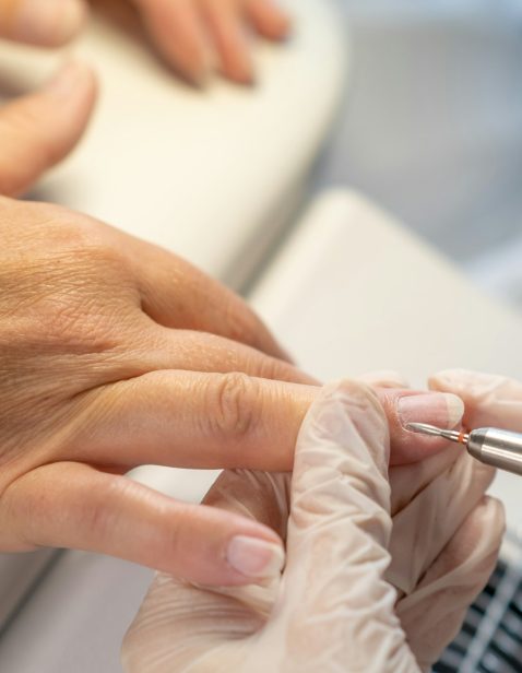 Female hands and tools for manicure, process of performing manicure