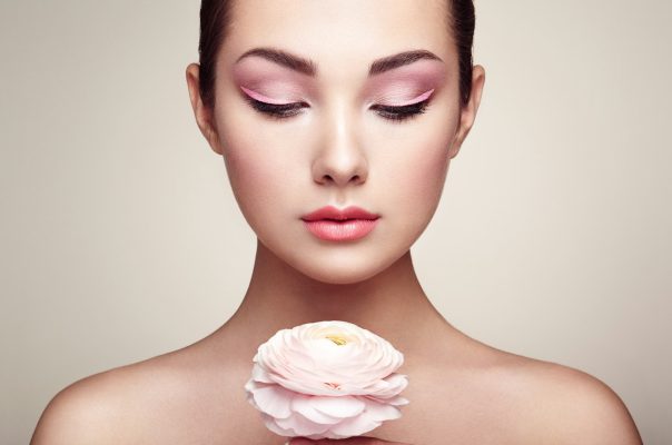 Portrait of beautiful young woman with flowers